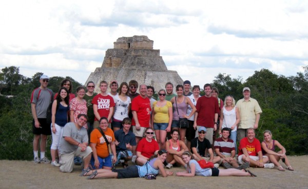 The group poses in front of ruins