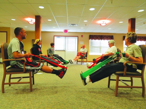 Fitness after Fifty students Alayna Bailey ’14, Jason Breon ’13 and Philip Heisterkamp ’13 helped Vriendschap Village residents exercise to avoid falls — the leading cause of injury for Americans over 65.