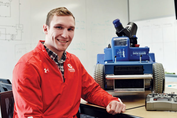 Cory McCleary ’18 with the Ankle Biter, the robotic snow blower he designed and built with fellow engineering student Jacob Challen ’18.